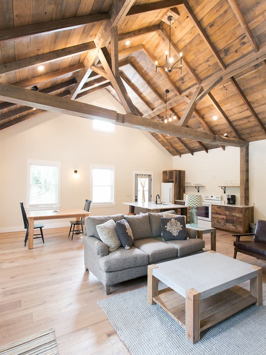 Interior of Barn Suite with couch, chair, kitchen, and dining table