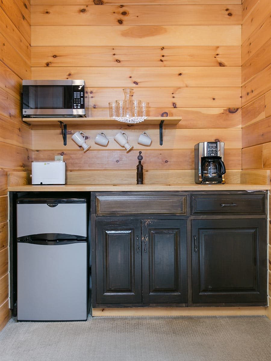 Kitchenette with coffee maker, toaster, microwave, and fridge