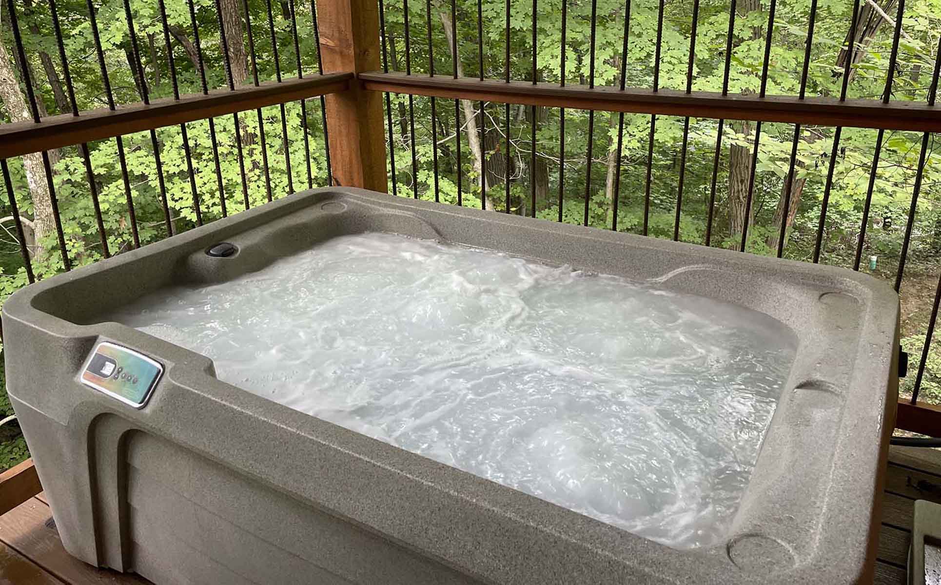 Hot tub on outdoor porch of treehouse