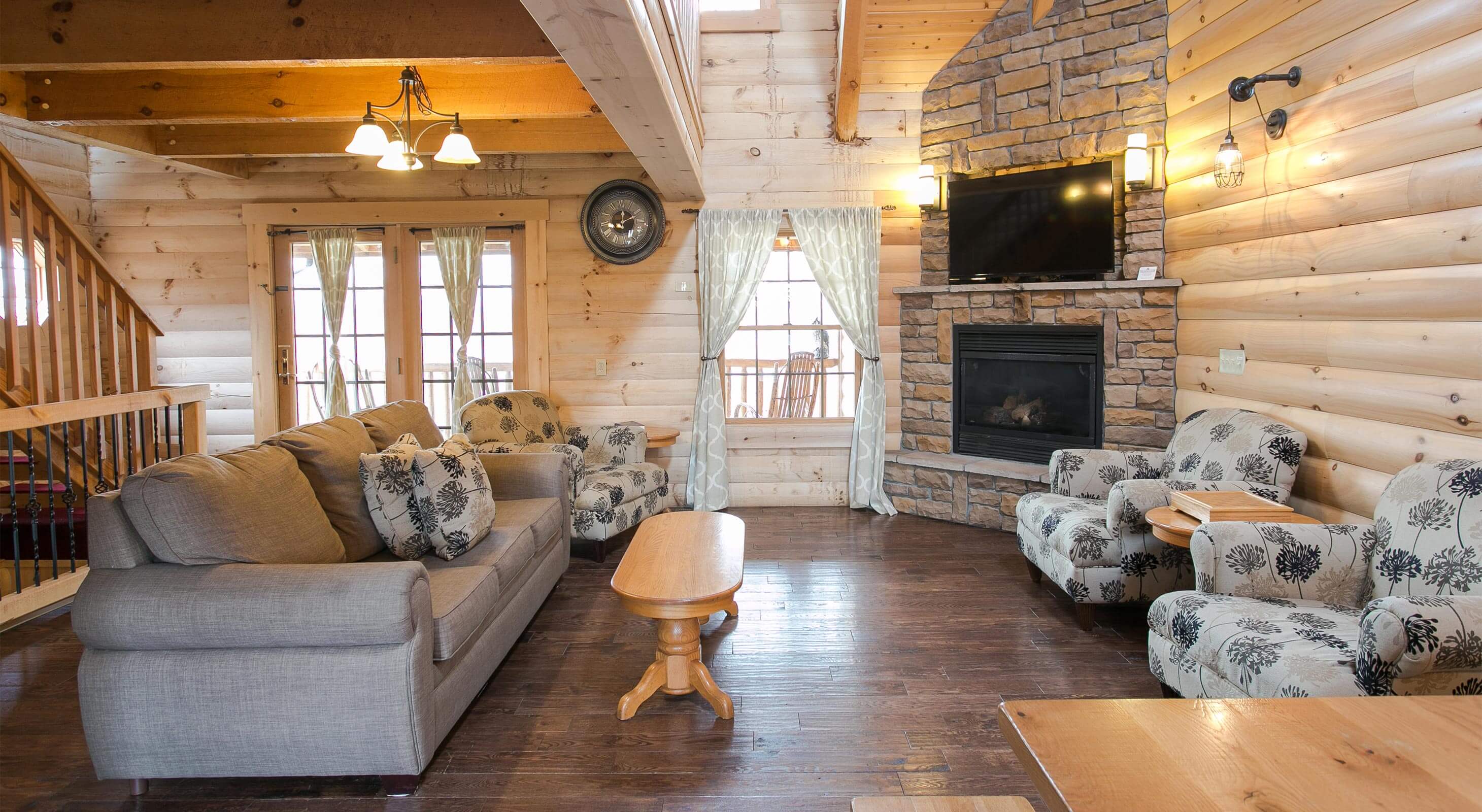 Living Room with rock fireplace in Hummingbird Haven