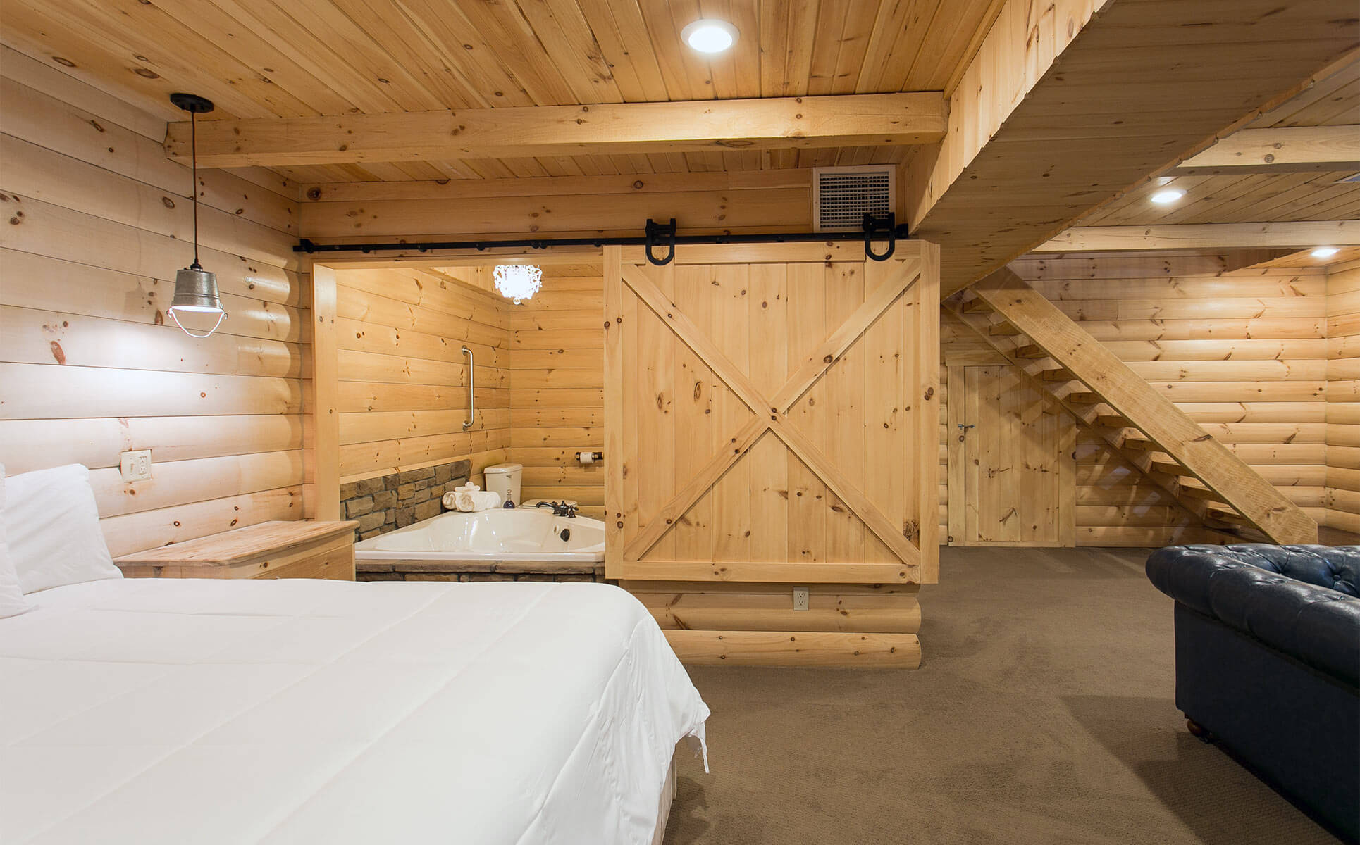 Bed in lower level with view of jetted tub