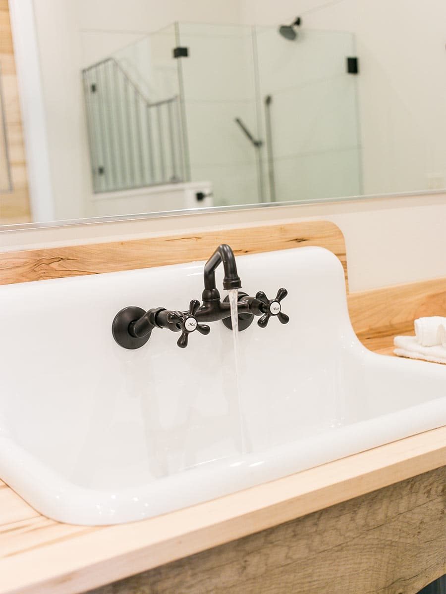 trough sink with reflection of shower in mirror