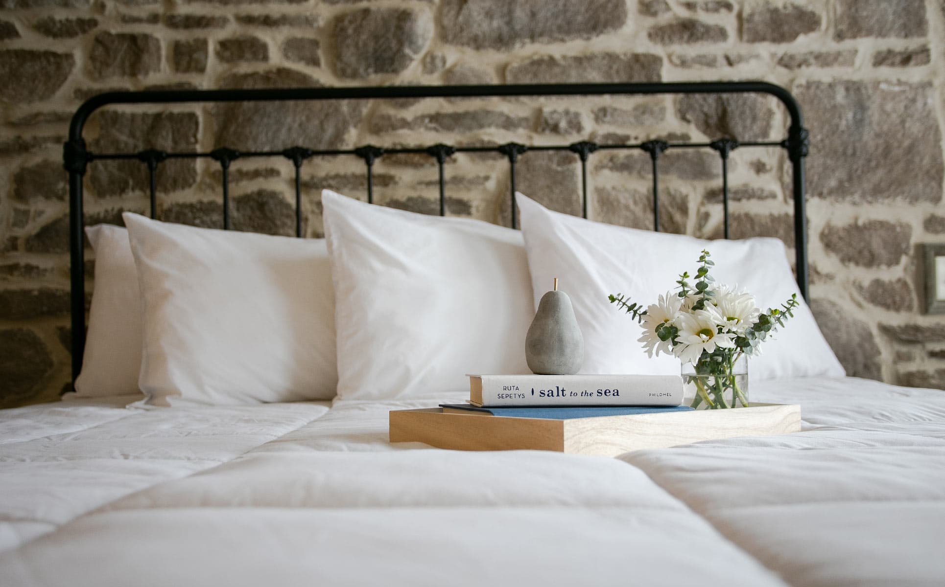 Closeup of Bed with books and flowers