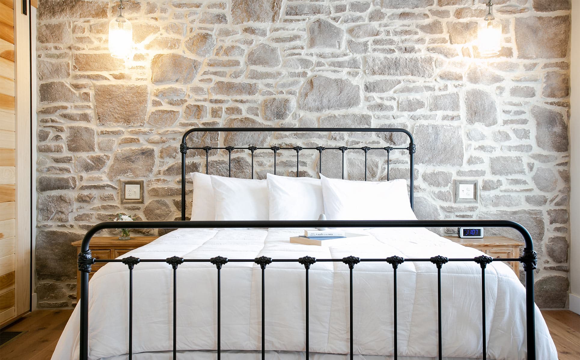 King bed against stone wall