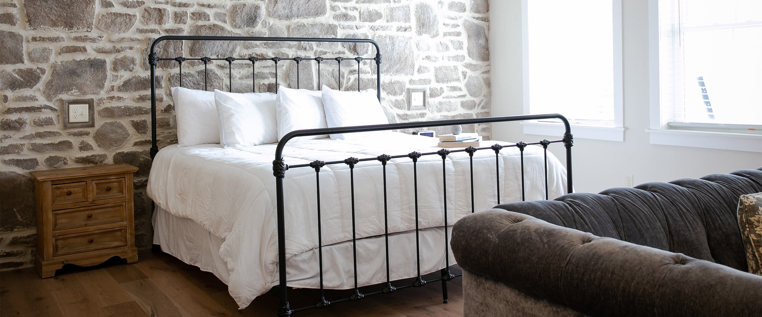 Magnolia suite bed against stone wall