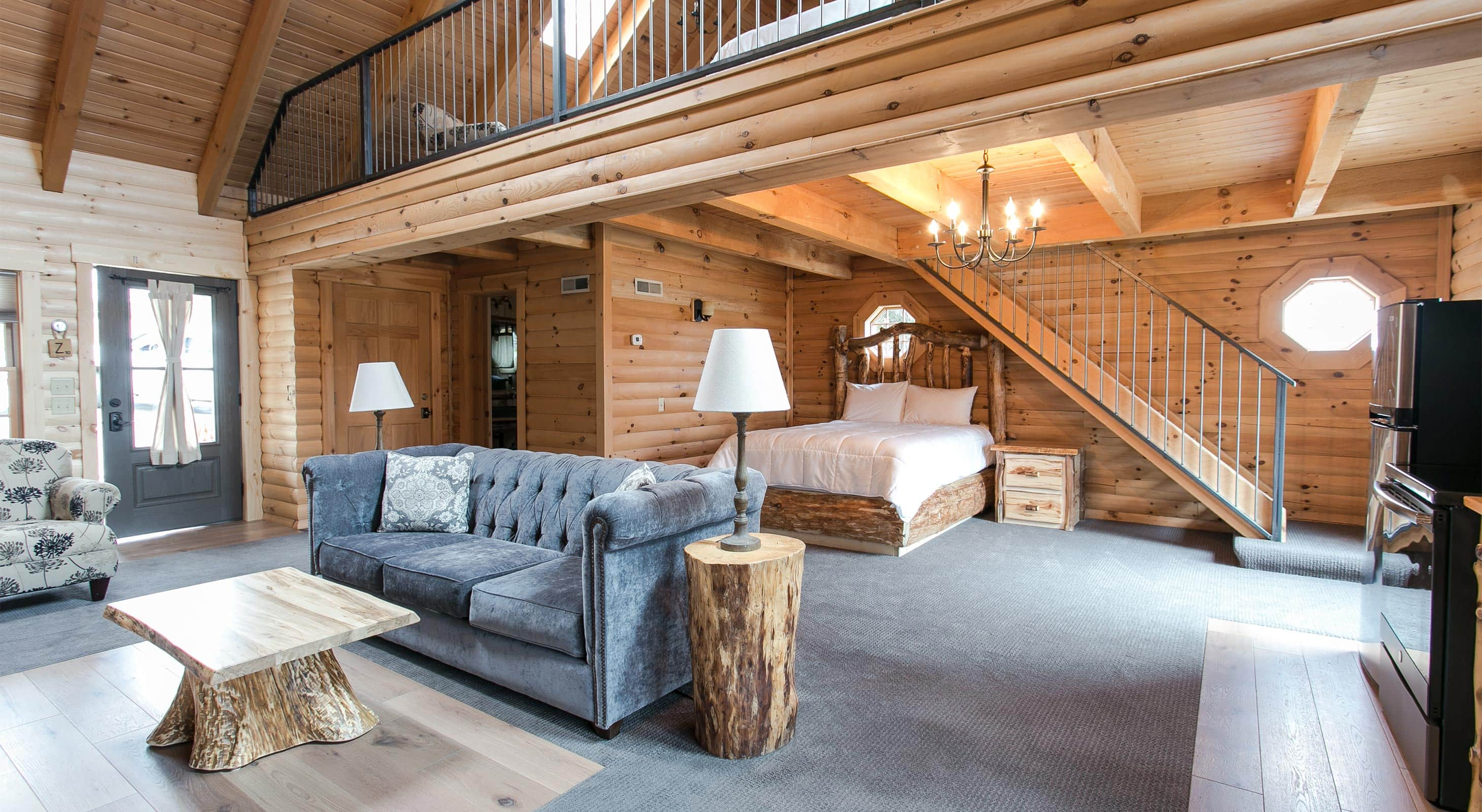 Main floor with couch and bed, loft above