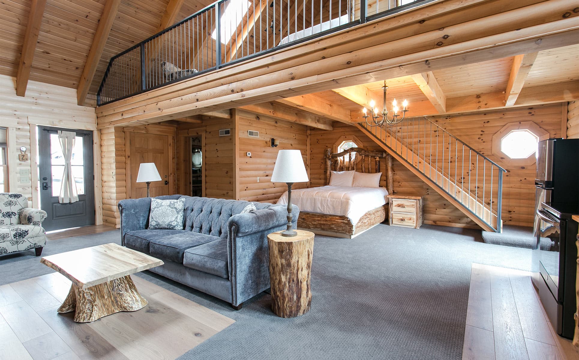 Main floor with couch and bed, loft above