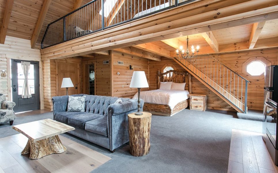 Main floor with couch and bed, loft above