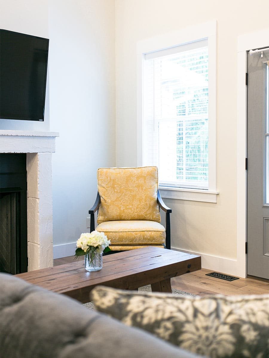 Chair with yellow cushions in living area