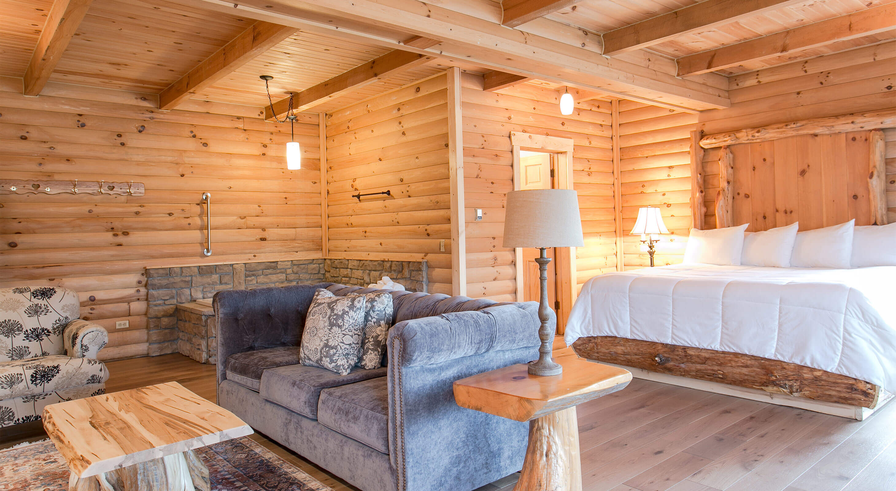 Bed, couch, chair, and tub in Rabbit's Nest Cabin