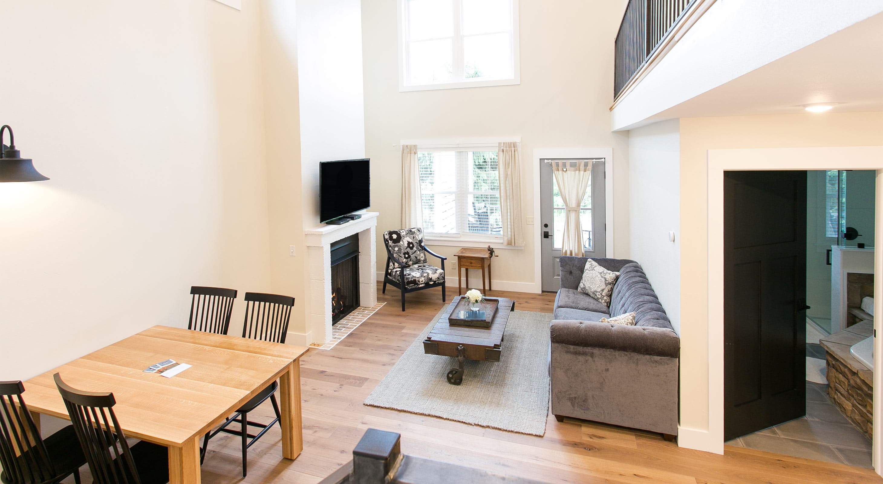 Couch, chair and tv in living room along with dining room table