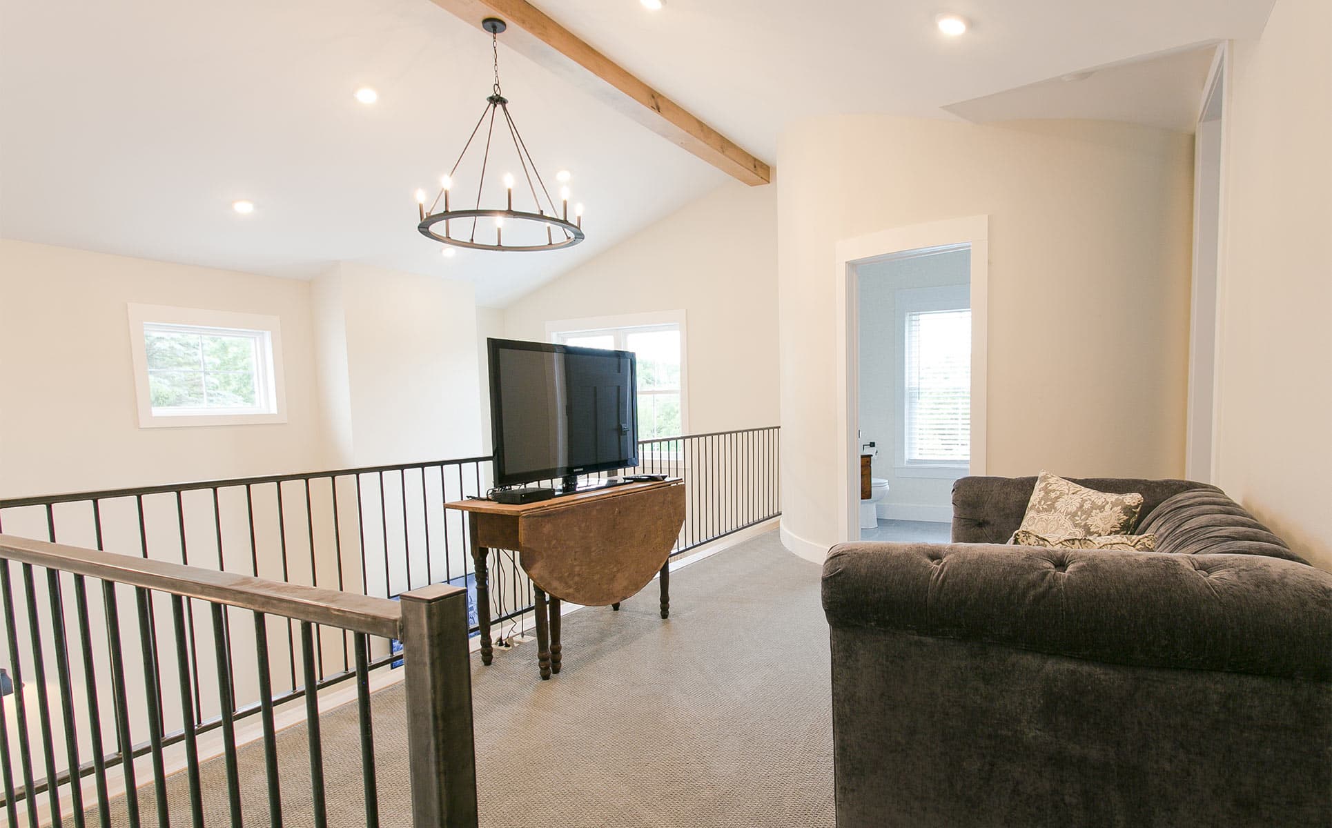 Loft with Television and chandelier in background