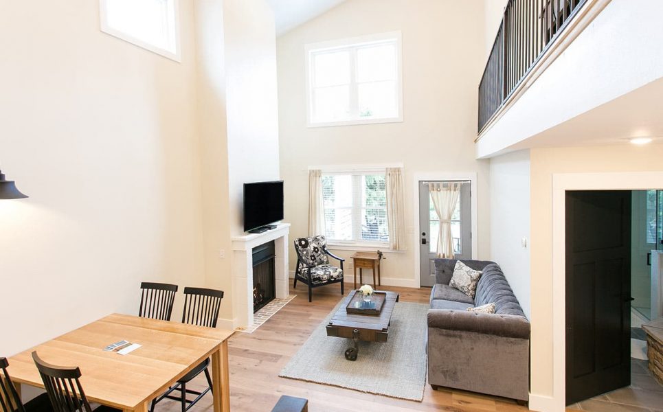 Couch, chair and tv in living room along with dining room table