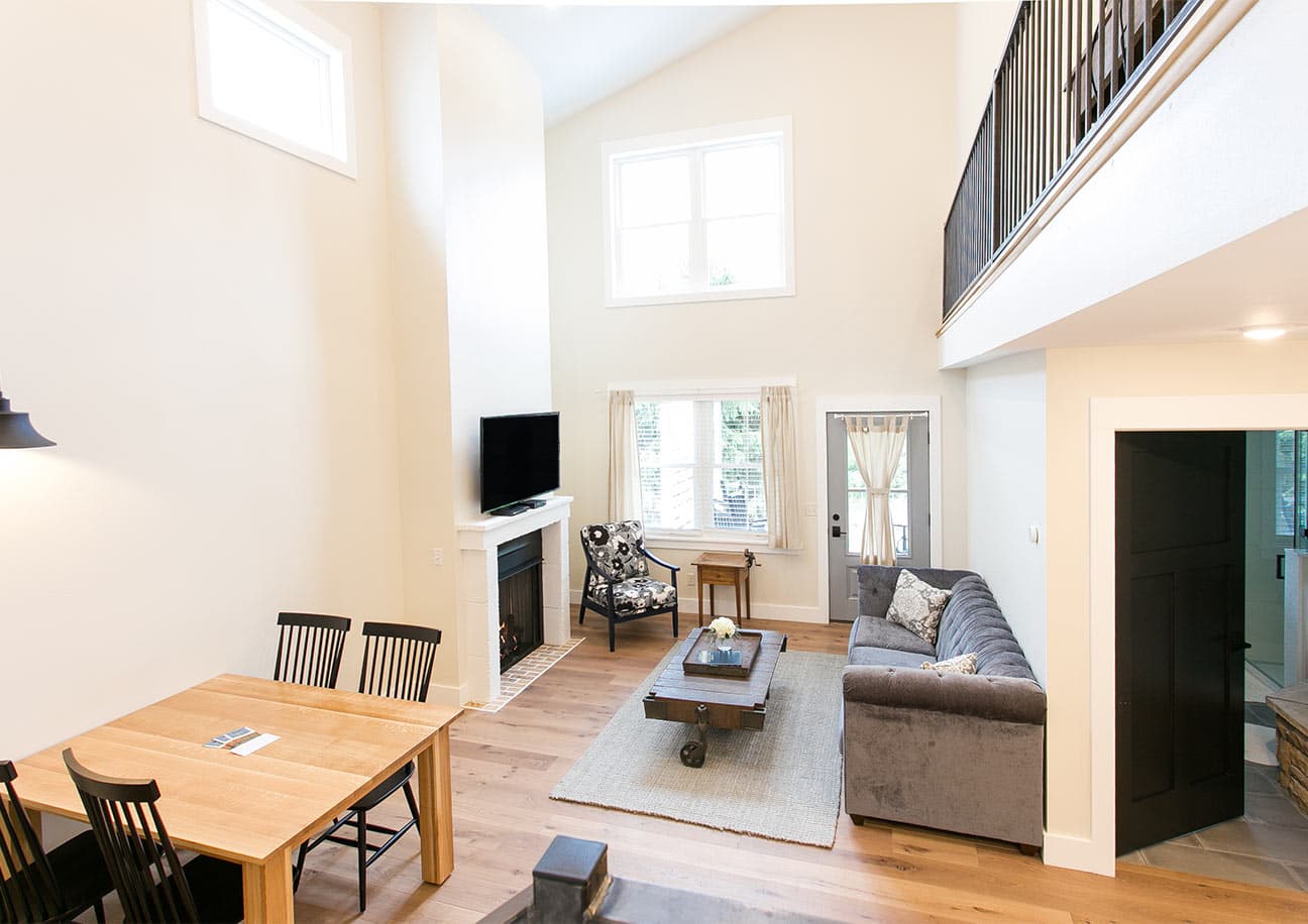 Couch, chair and tv in living room along with dining room table