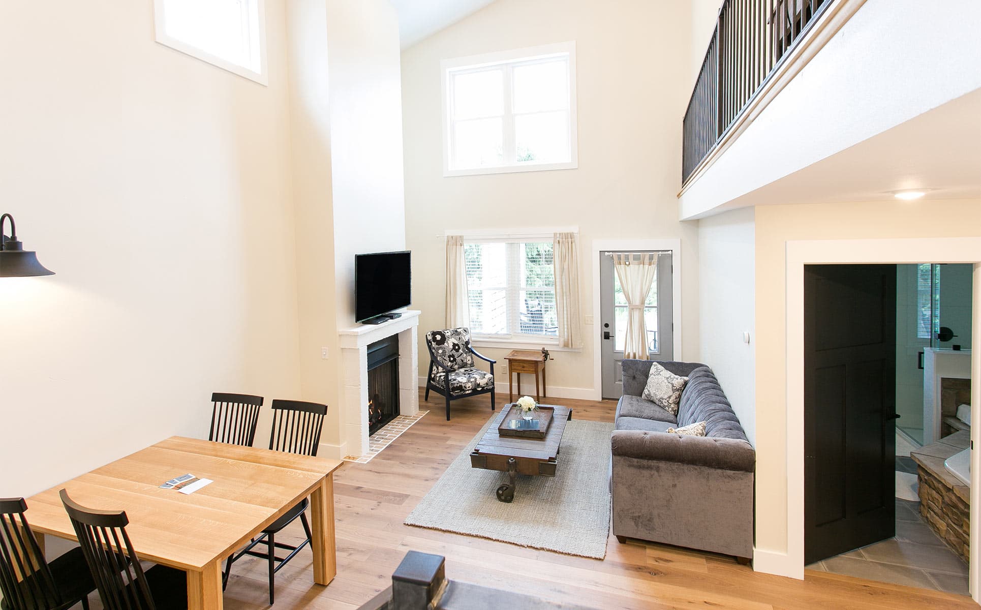 Couch, chair and tv in living room along with dining room table