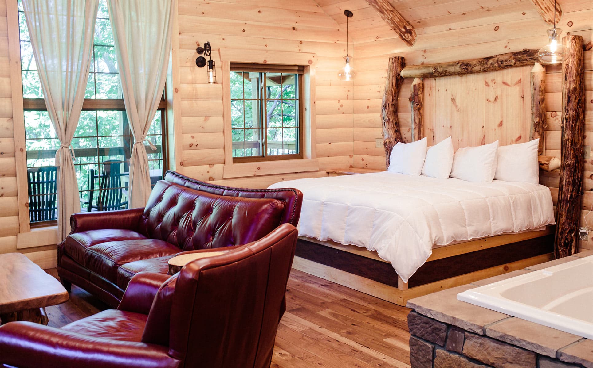 Bed, Red Couch, and tub in Treehouse F