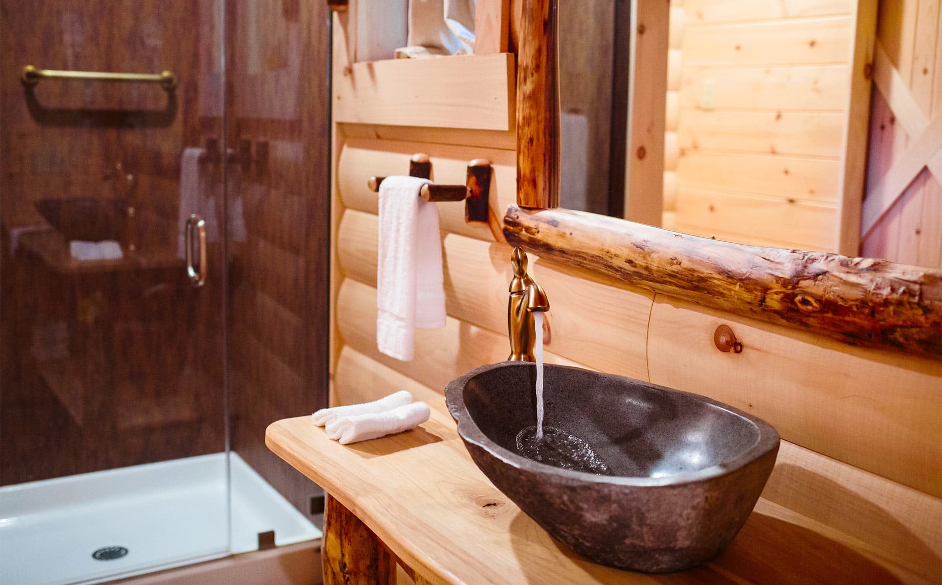 vessel sink in bathroom with shower in background