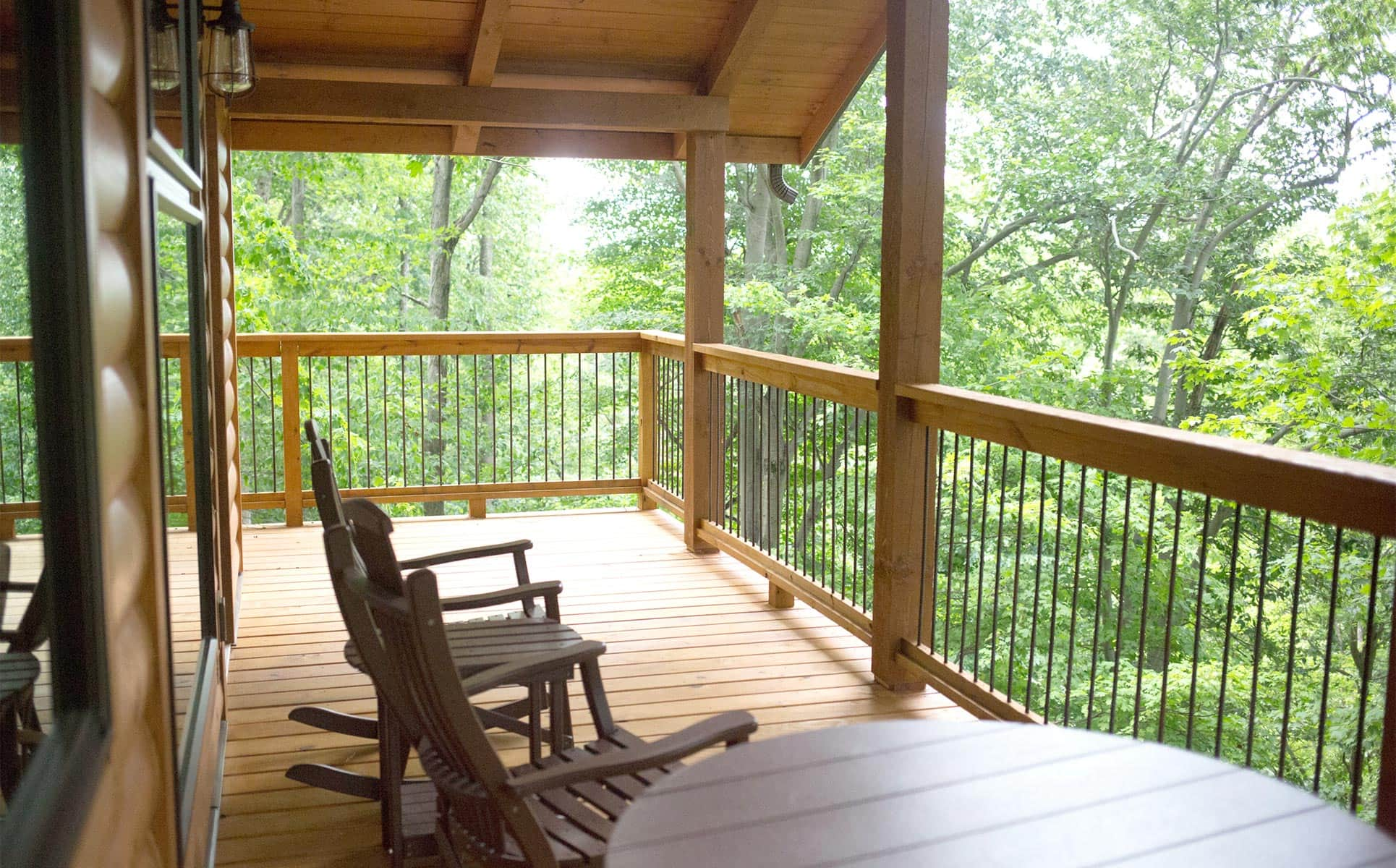 Deck with rocking chairs and view of the trees