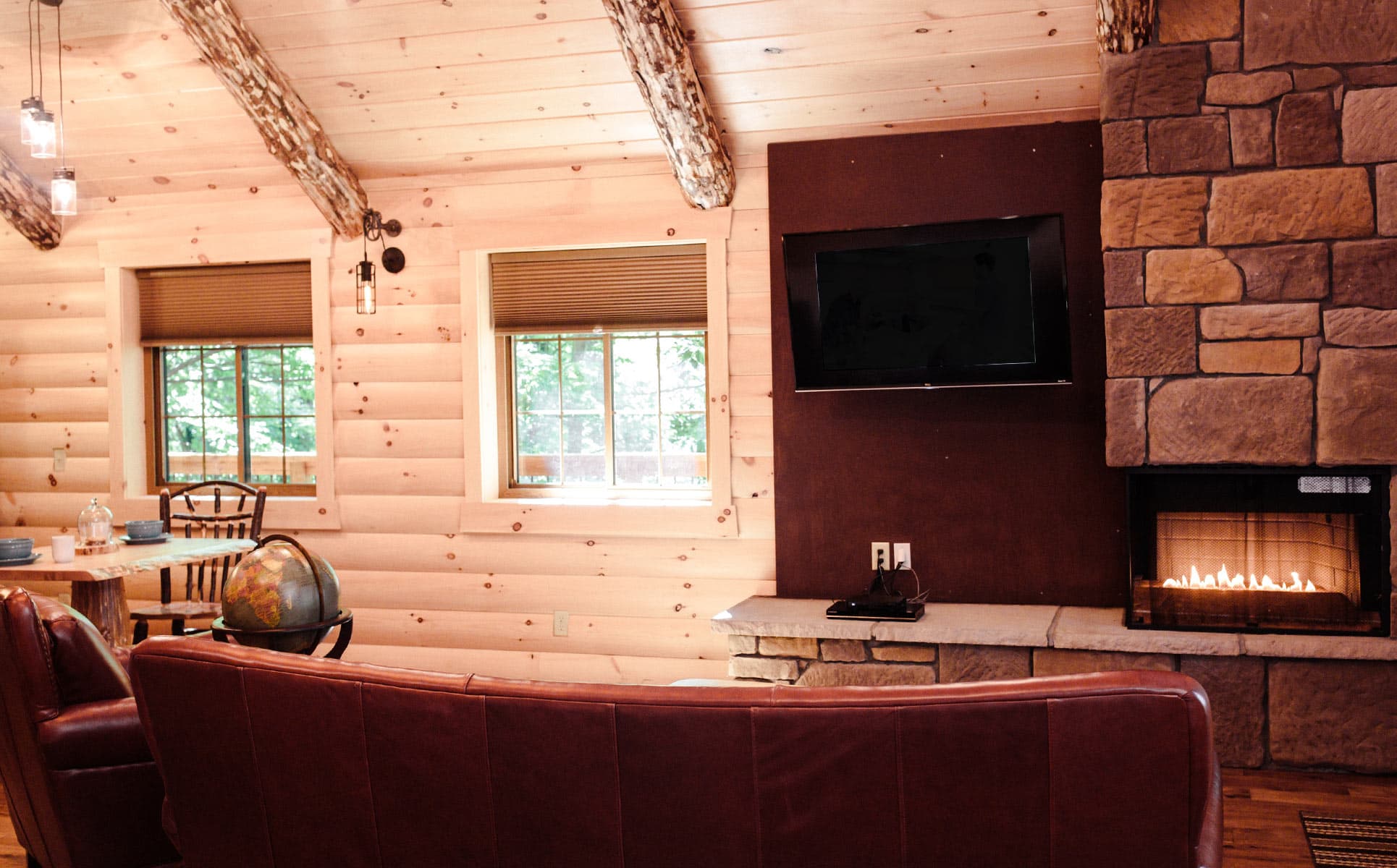 Fireplace, red couch, and television