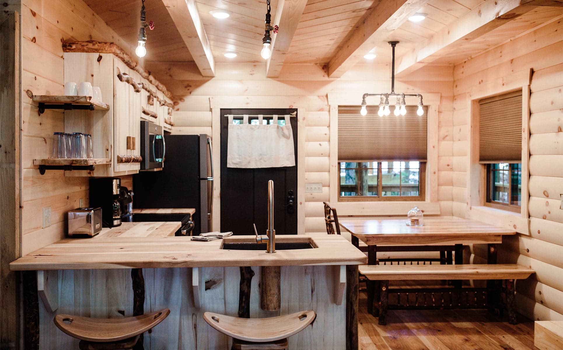 Kitchen with bar stools and dining table