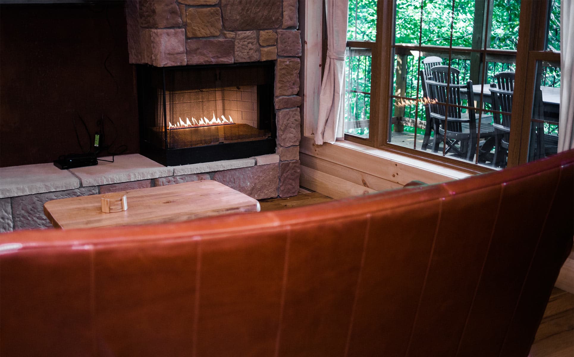 Gas fireplace with red leather couch