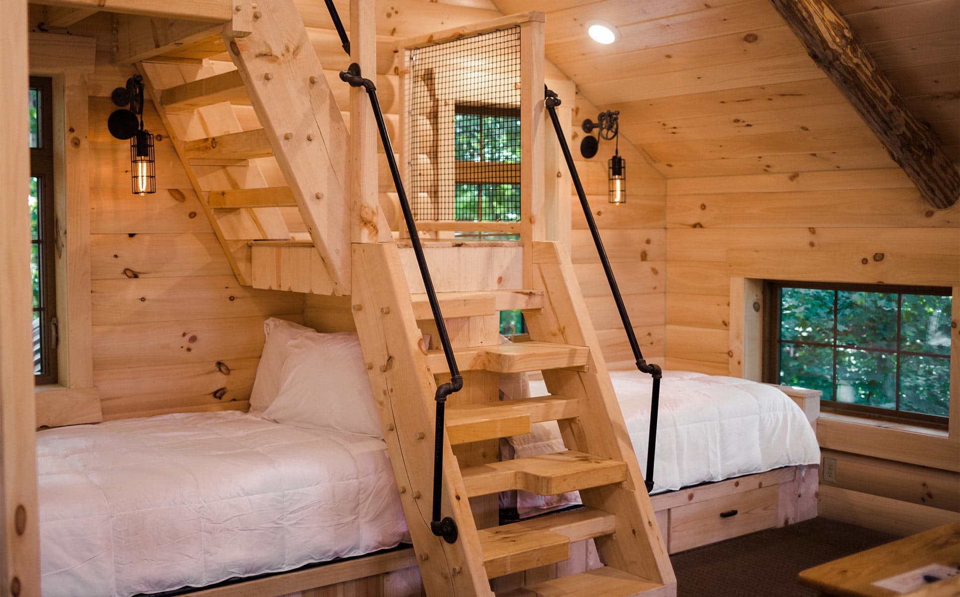 Twin beds in the loft with stairs to crows nest