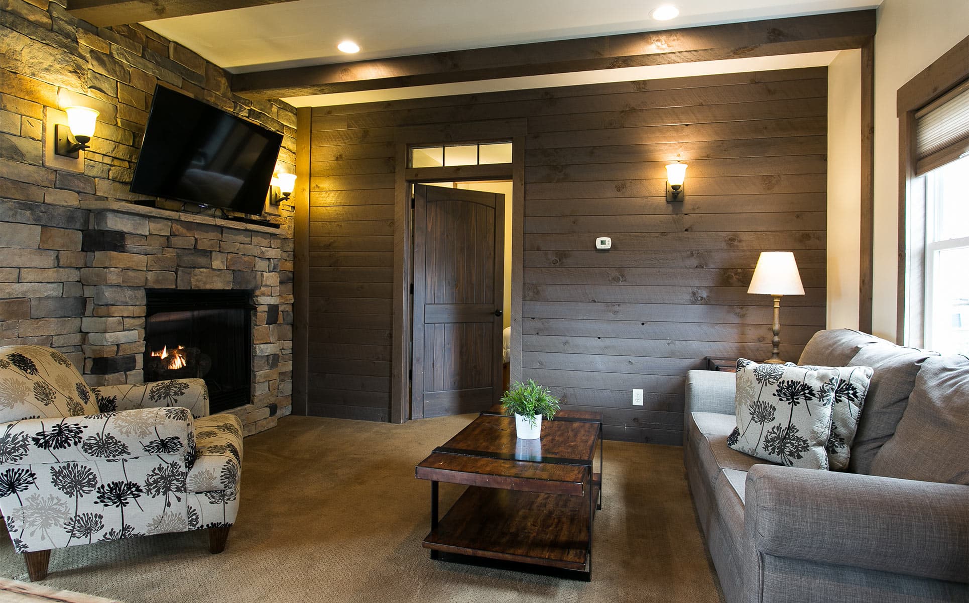 Living room with Gas Fireplace and wood wall