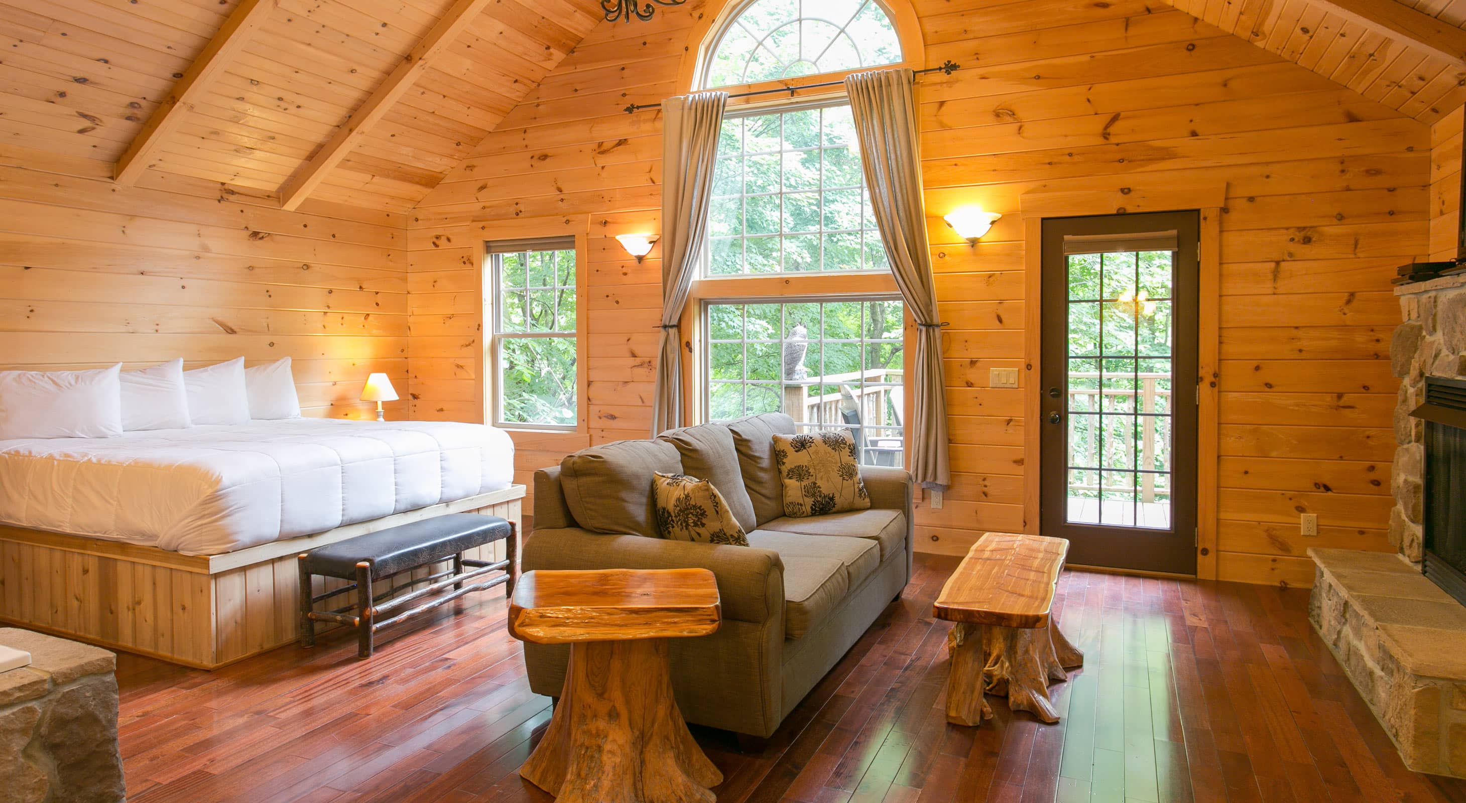 Interior of Treehouse with bed, couch, & stone detail